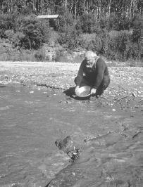 A miner pans for gold near Dawson. During the Klondike gold rush of 1898, Dawson&#x0027;s population swelled to 30,000, making it the biggest city north of San Francisco at the time. Canadian Tourism Commission photo.