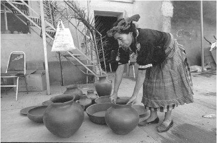 &#x00A9; Catherine Karnow/Woodfin Camp A woman with her pottery.