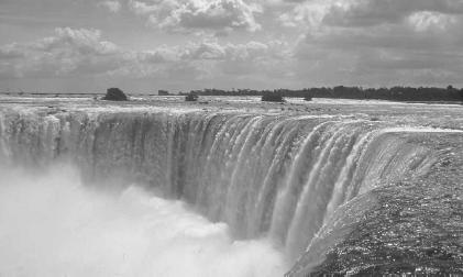 Niagara Falls, along the border of the United States, drains about 800,000 gallons (3 million liters) of water per second from the short Niagara River. Canadian Tourism Commission photo.