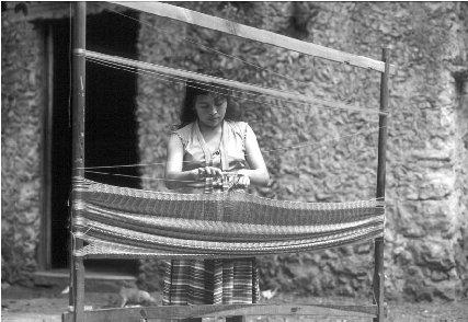 © Kal Muller/Woodfin Camp A Mayan woman weaves a hammock.